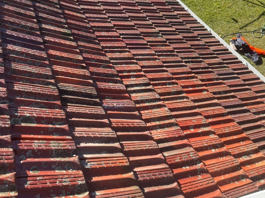 Completed tiled roof with original tiles relaid over new sarking and a new gutter along the eave