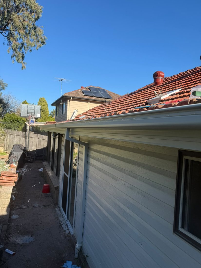 New quad gutter and fascia covers installed along the full length of the eave