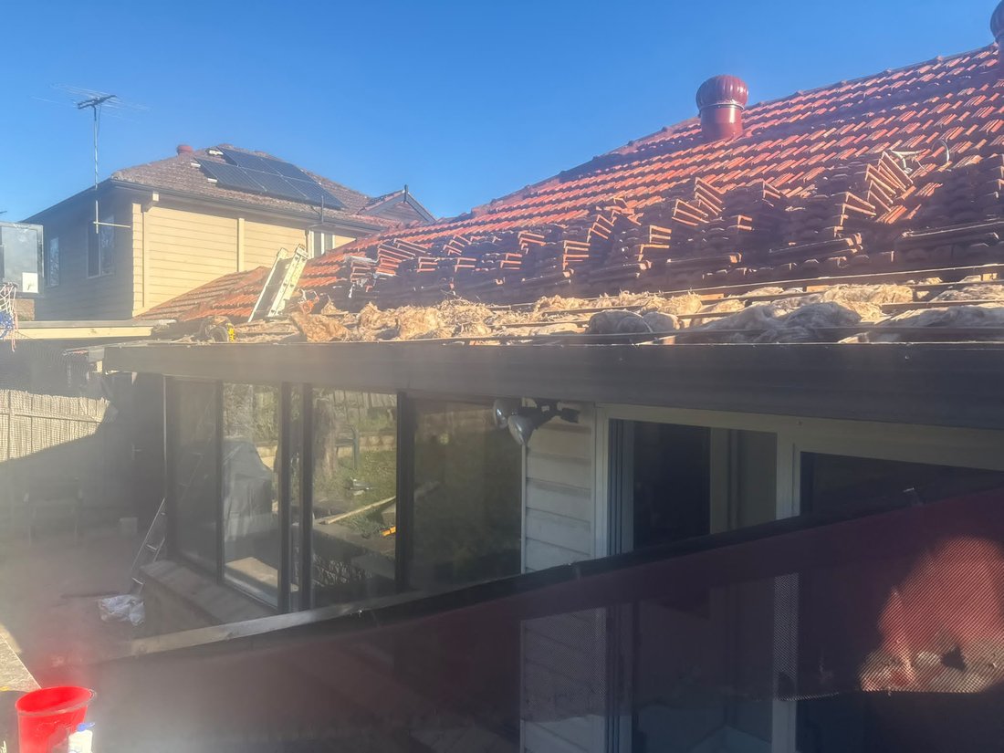 Old gutter stripped off leaving bare weathered fascia timber and exposed rafter ends