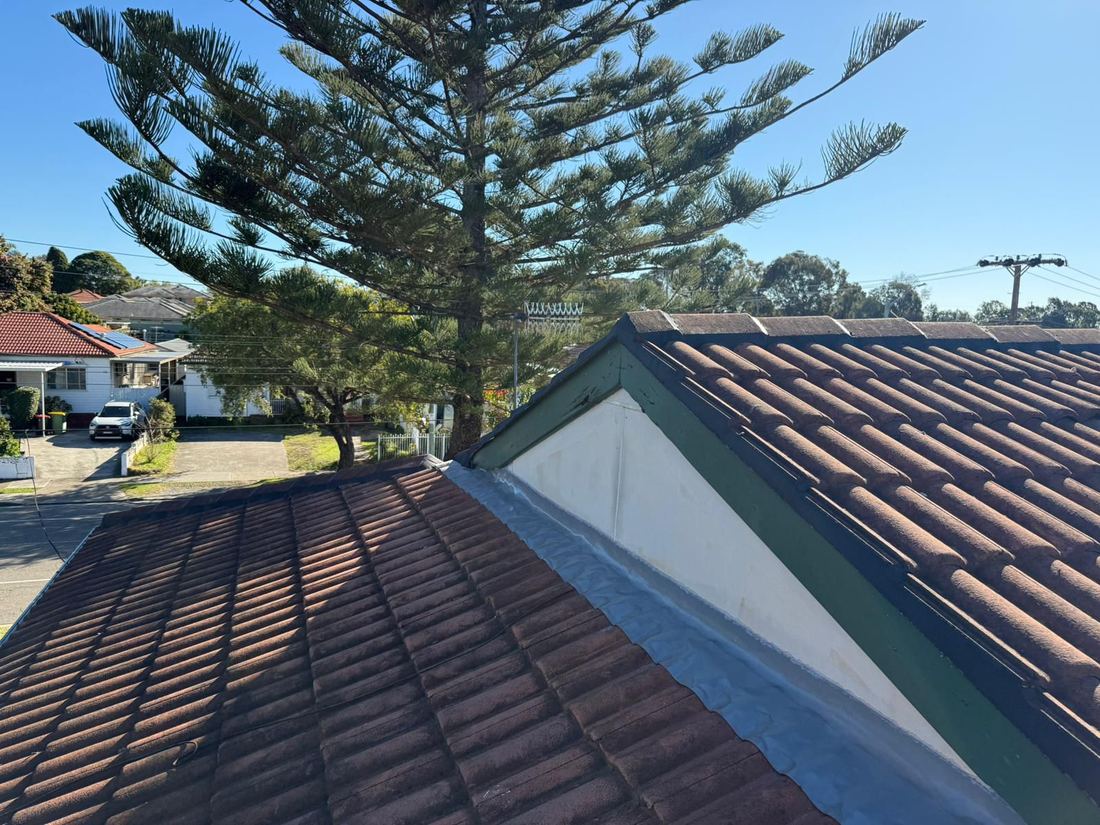 Aussie Roof Repairs team working on a tiled roof in Sydney