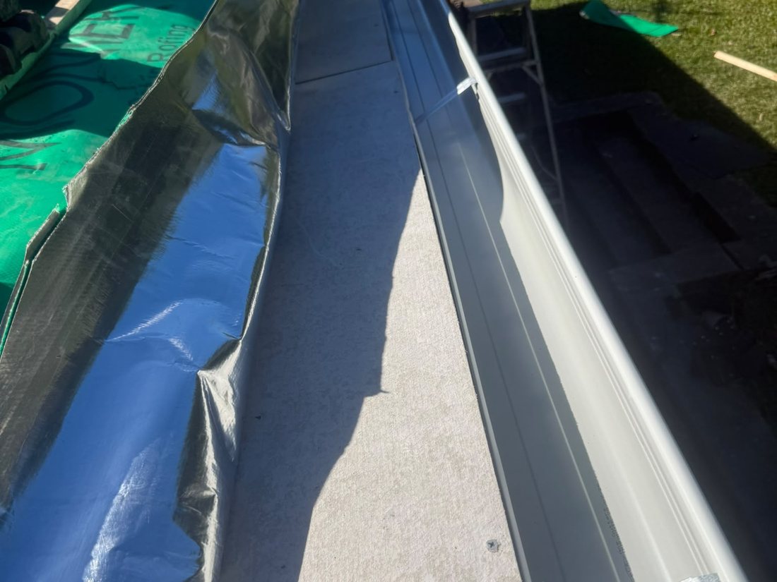 Roof sarking carried down over the eave and finished above the gutter line